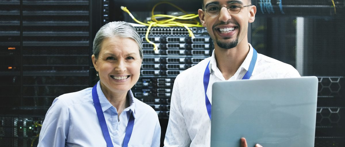 Two colleagues working from a shared technical reference